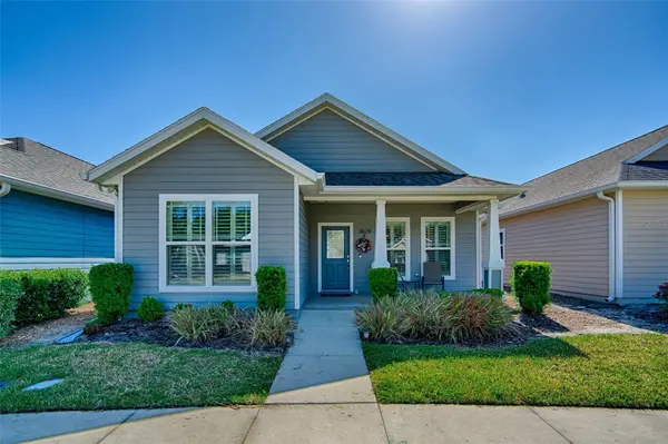 Blue craftsman bungalow with manicured landscaping in NW Gainesville